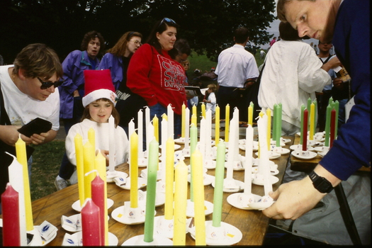 People buying candles at stall 