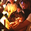 Woman holding young girl on her lap amongst candlelight crowd