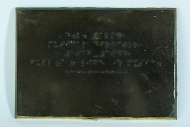 Braille writing on brown plaque