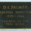 Large text in gold on brown plaque