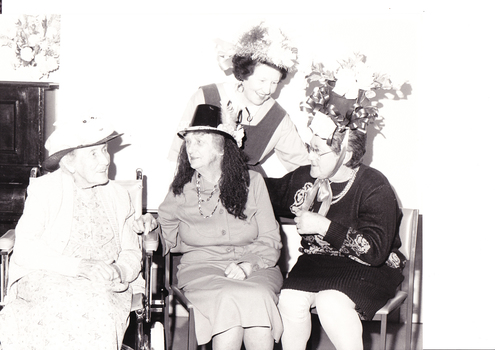Four women chat during the Easter Bonnet parade