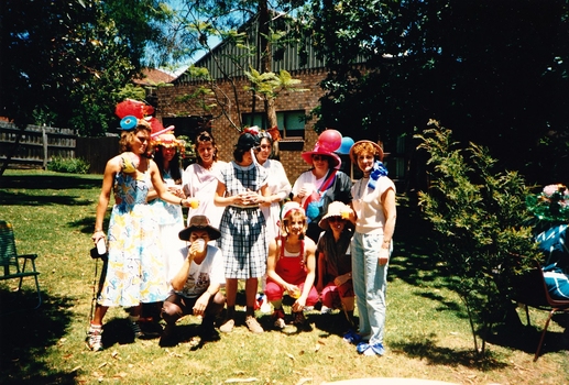 10 people, most wearing Easter bonnets, possibly at Kooyong