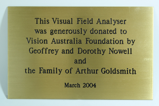 Gold coloured plaque with black writing