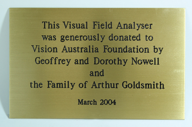 Gold coloured plaque with black writing