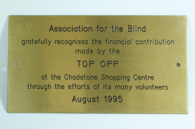 Gold coloured plaque with black writing