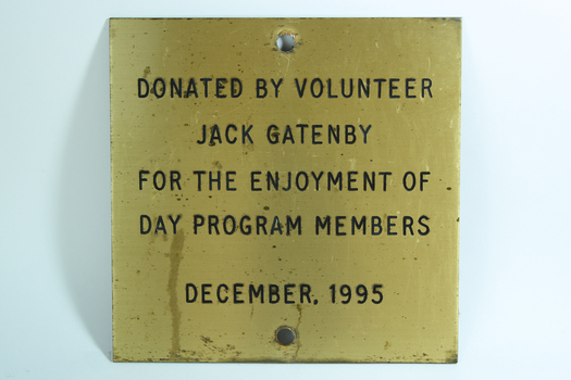 Gold coloured plate with black writing