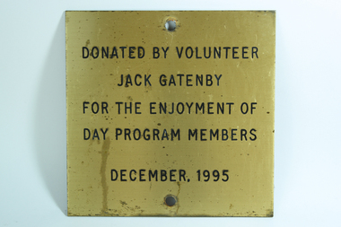 Gold coloured plate with black writing