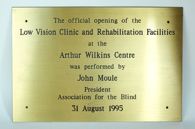 Gold coloured plaque with black writing