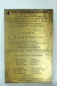 Gold coloured plate with brown inscription