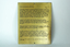 Gold coloured plate with brown inscription