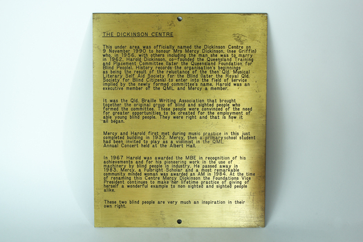 Gold coloured plate with brown inscription