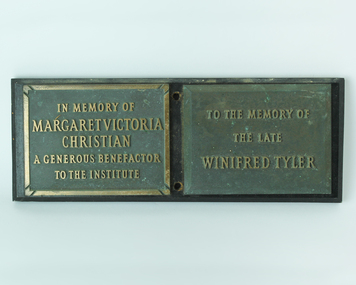Two plaques attached to a board