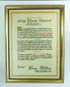 Gold frame for citation written in copper plate style on brownish coloured parchment paper