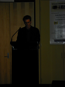 Narrator Paul English at the podium