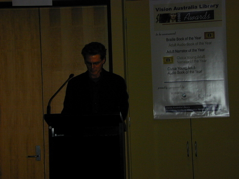 Narrator Paul English at the podium