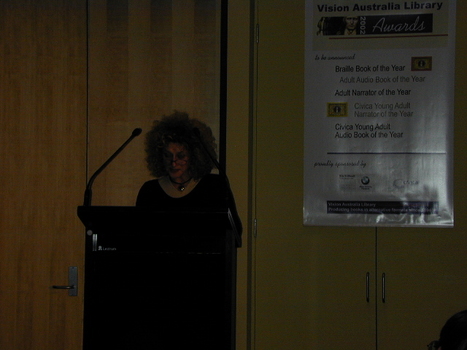 Narrator Evelyn Krape at the podium
