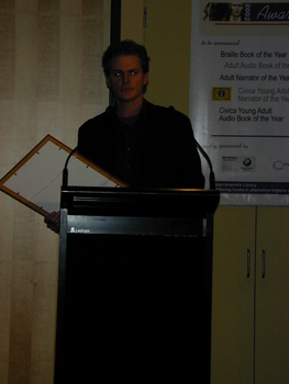 Narrator Paul English at the podium