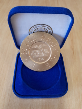 Gold coloured medallion in blue velvet box