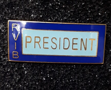 Enamel blue badge with gold writing