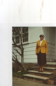 Photograph of Grace Hoppitt outside a house in her Australian uniform