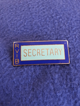 Blue enamel name badge with gold writing