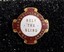 Red and white badge with gold edging