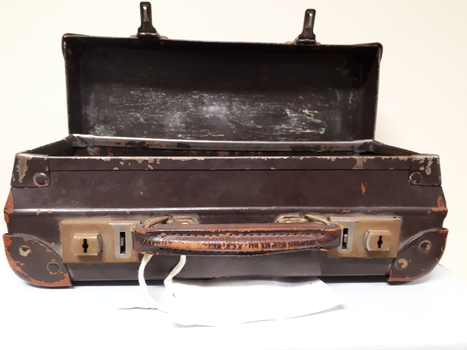 Battered small brown suitcase with rusted locks