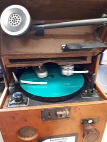 Leather covered box with flip top and turntable with two heads for inscribing and reading, metal speaking tube and various knobs and levers