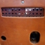 Rear view of leather covered box with rattan air flow grill and ports for cords