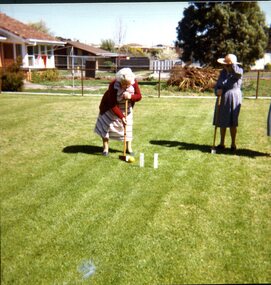 Two women playing croquet at Kelaston