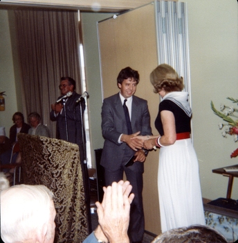Lilian Dethridge receiving a gift at podium