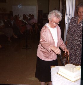 Mrs Hamill cutting the anniversary cake