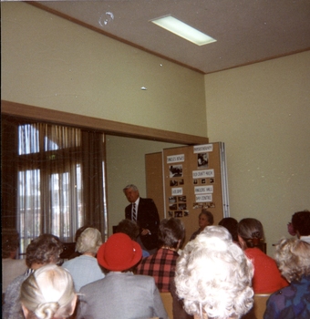 Older male speaking at the podium