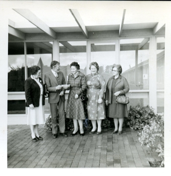 3 Women present a cheque to a man and Matron