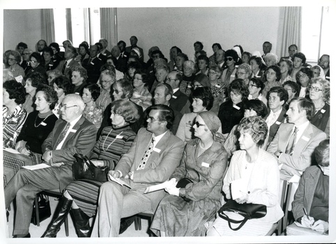 Audience members listen to Sir Henry Bolte