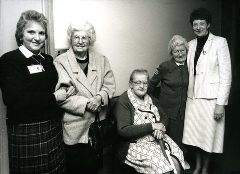 Three residents with two staff members at the retirement party for Mrs Hay