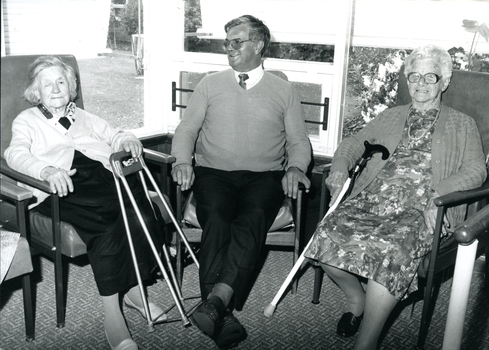 Two residents sit either side of manager Don Dunstan