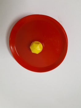 Red circular plastic card holder with a yellow button in the centre