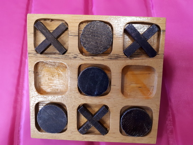 Wooden 3 x 3 grid with wooden circles and crosses