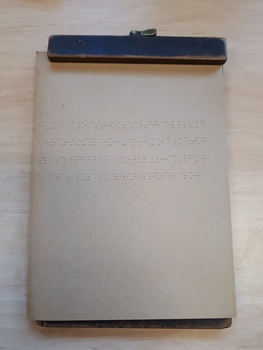 Wooden board with two hinges and braille paper