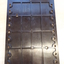 Brown plastic rectangular hand frame with holes evenly spaced on either long side.