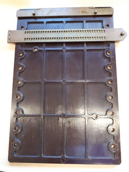 Brown plastic rectangular hand frame with metal guide