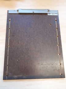 Brown hand frame with holes evenly spaced on side and metal clip