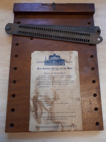 Brown rectangular wooden board with hinged paper clamp