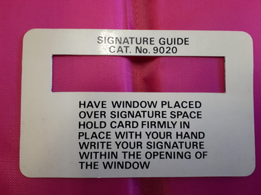White card with black writing and window for signature