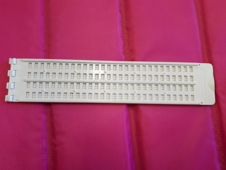Cream coloured slate with 4 lines of 28 cells and side hinge
