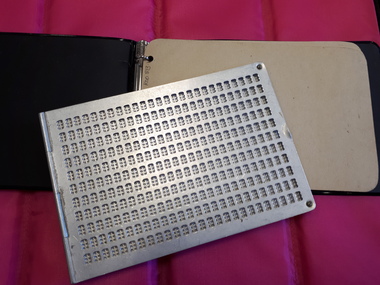 Metal postcard sized frame with A5 ring binder with braille paper