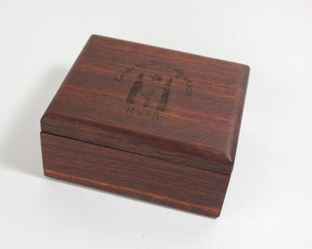 Dark wooden box with Carols logo on hinged lid