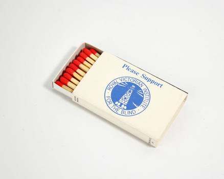 Blue writing on white box containing wooden matches with red head