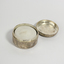 Small round silver tin with inscription on lid and tea candle inside